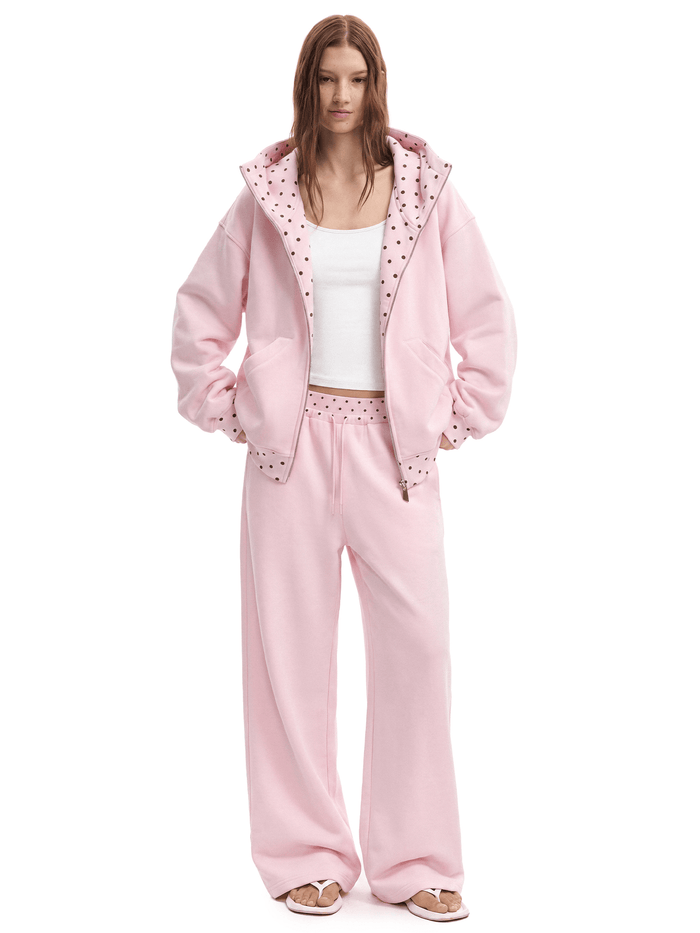 Pink hoodie and matching sweats on model