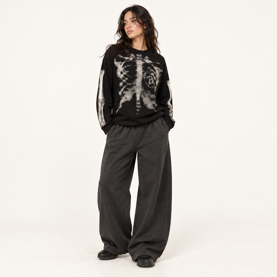 Model wearing Black ribcage tee with black wide-leg sweats