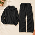 Black complete half-zip top and wide-leg pants matching set — flat lay